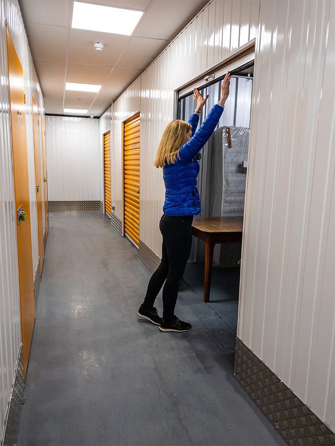 Woman closing storage unit