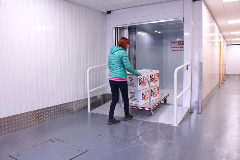 woman wearing green jacket doing self storage