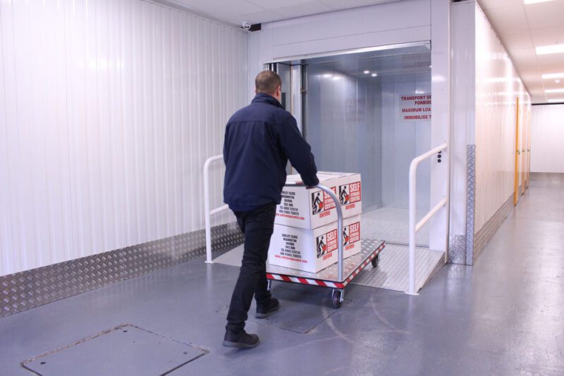 man wearing blue jacket doing self storage